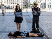 Happening against conjugal violence in the streets of Lyon, France, on July 18, 2017. 
A woman wears a sign 