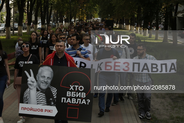 A few hundred activists and media representatives march downtown Kyiv, Ukraine pass by the President Office and Internal Ministry from the s...
