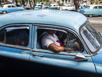 A woman in the interior of a car in Havana, Cuba.
 (