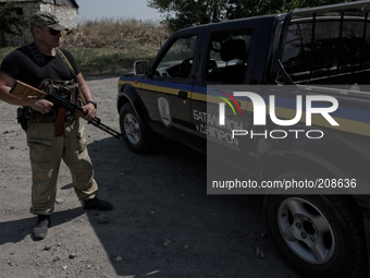 UKRAINE - AUGUST 7: Soldier of Dnipro battalion patrols a town near the Ukrainian-Russian border (