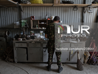 UKRAINE - AUGUST 7: Soldier Border Troops prepares tea inside a motor repair shed where soldiers find a shelter for a night (