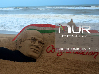 A sand sculpture of newly elected President of India Ramnath Kovind's is seen at the Bay of Bengal Sea's eastern coast beach at Puri as it c...