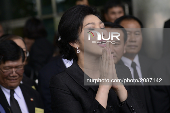 Ousted former Thai Prime Minister Yingluck Shinawatra speaks with members of Thai media as she arrives at the Supreme Court in Bangkok, Thai...