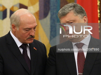 President of the Republic of Belarus Alexander Lukashenko, on the left, and Ukrainian President Petro Poroshenko, on the right, talking duri...