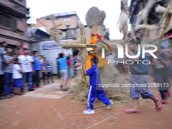 Nepalese devotees rotating straw effigy demon Ghantakarna during the Gathemangal festival celebrated at Bhaktapur, Nepal on Friday, July 21,...