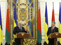 Belarussian President Alexander Lukashenko (L) and Ukrainian President Petro Poroshenko (R) speaks with journalists during a press-conferenc...