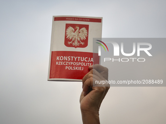 A protestor hold a copy of Polish Constitution outside the Regional Court during ' Chain of Light ' during another day of protests against g...