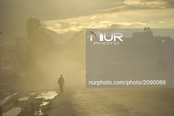A man walks through mass of dust and air pollution at Patan, Nepal on Saturday, July 22, 2017. Kathmandu has been ranked as the third most p...