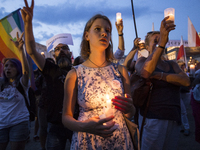 Anti-government protesters gathering in Main Square in Krakow , raise candles and shout slogans during a demonstration against a new bill ch...