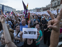Anti-government protesters gathering in Main Square in Krakow , raise candles and shout slogans during a demonstration against a new bill ch...