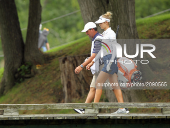 Nelly Korda of the United States and her caddie cross the bridge on the way to the second green during the third round of the Marathon LPGA...