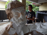 Artist Max Santiago paints an effigy of President Rodrigo Duterte, which will be used in the protest coinciding President Rodrigo Duterte's...