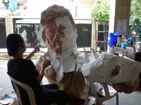Artist Max Santiago paints a part of an effigy of President Rodrigo Duterte, which will be used in the protest coinciding President Rodrigo...