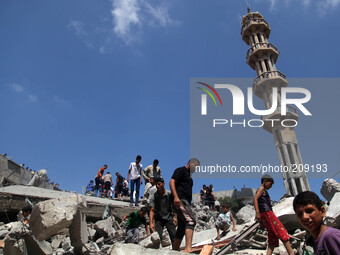 Palestinians inspect the rubble of  the Al-Qassam mosque  following an Israeli airstrike in Gaza City, on August 9, 2014. Israel launched mo...