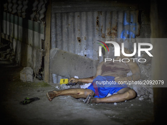 The body of a man lies dead next to a revolver after he was killed in a shootout with police in Caloocan, Metro Manila, Philippines, July 20...