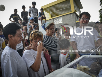 Relatives mourn during the funeral of Nino Maruso, who was killed by police in what they say was a drug buy-bust operation, in Manila, Phili...