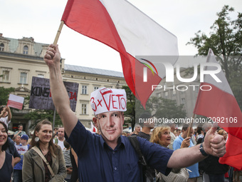 A man wearing a mask of president Andrzej Duda protests at the Main Square against government plans for sweeping changes to Polands judicial...