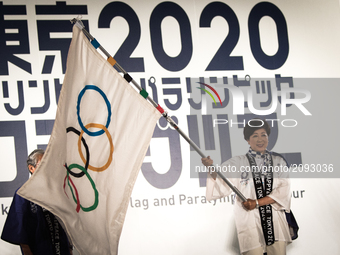 Tokyo Gov. Yuriko Koike waves an Olympic flag during the Tokyo 2020 flag tour festival for the 2020 Games at Tokyo Metropolitan Plaza in Tok...