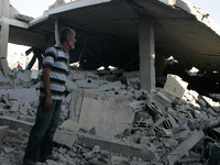 Palestinian man looking at his house after was hit by an Israeli military strike in Rafah in the southern Gaza Strip on August 10, 2014. Isr...