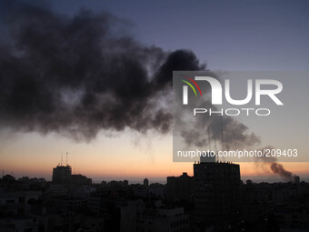Smoke raises over Gaza City after an Israeli airstrike Sunday, Aug. 10, 2014.  (