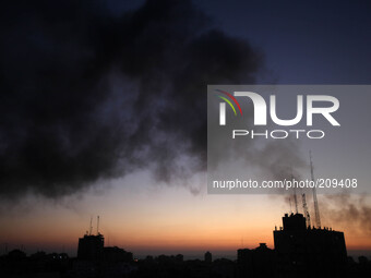 Smoke raises over Gaza City after an Israeli airstrike Sunday, Aug. 10, 2014.  (