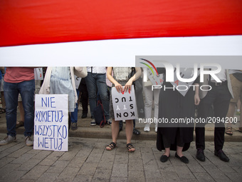 Protesters hold banners during protest against government plans of changes to Poland’s judicial system in Warsaw on July 25, 2017.
 (