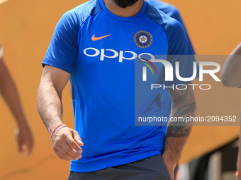 Indian cricket captain Virat Kohli  walks in the ground after a press conference  to take part in a practice session ahead of the 1st test m...