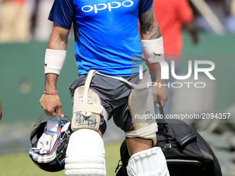 Indian cricket captain Virat Kohli walks away after taking part in a practice session ahead of the 1st test match between Sri Lanka and Indi...