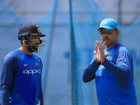 Indian cricketer Rohit Sharma(L) listens to Indian head coach Ravi Shastri(R) during a  practice session ahead of the 1st test match between...