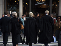 Lawyers are pictured outside The Royal Court Of Justice with their wigs, London on July 25, 2017. It has became the scene of the legal dispu...
