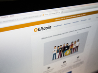 A view of a cryptocurrency Bitcoin website. Bitcoin is a cryptocurrency and a digital payment system invented by an unknown programmer, or a...