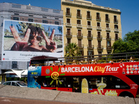 Tourists go by a touristic bus  on August 8, 2017 in Barcelona, Spain. In the past year there have been a series of protests as residents co...