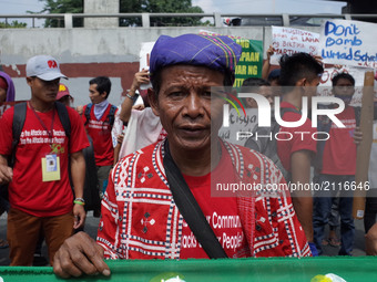 A Manobo indigenous tribesman poses for a photograph during a rally coinciding the International Day of the World's Indigenous Peoples outsi...