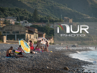 Vacationers enjoying the beach in Caronia, Sicily, Italy on 6 August 2015. (