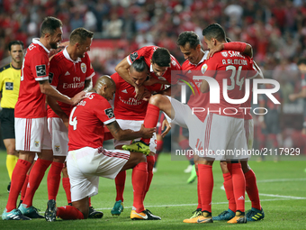 Benfica's Brazilian forward Jonas (2ndR) celebrates with teammates after scoring during the Portuguese League football match SL Benfica vs S...