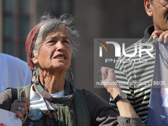 An elderly woman chants slogans as families and relatives gathered in front of the central railway station to commemorate the martyrs of Tur...