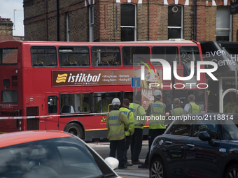 Police Officers, firemen and emergency workers are seen on the scene of a bus accident in southwest London, on August 10, 2017. A double-dec...
