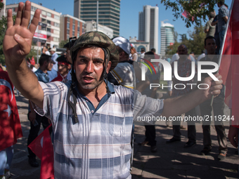 Pro-government demostrator wear a military helmet to a rally following the failed coup attempt. Photo taken 16 July 2016 (