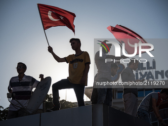 Pro-government demonstrators wave Turkish flags in central Ankara, Turkey, the day after the failed coup attempt on 16 July 2016. (