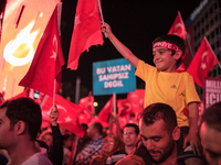 A child waves a Turkish flag during a nightly 
