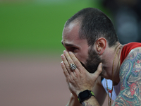 Ramil Guliyev of Turkey celebrates as he crosses the line to win the mens 200 metres final during day seven of the 16th IAAF World Athletics...