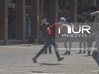  A Kashmiri Muslim protester throws stones at Indian government forces  during an anti India protest on August 11, 2017 in Srinagar, the sum...