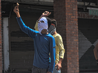  A Kashmiri Muslim protester shows piece of brick to Indian government forces during an anti India protest on August 11, 2017 in Srinagar, t...