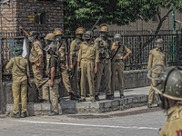  Indian government forces look towards Kashmiri Muslim  protesters shouting  anti Indian and pro Kashmir freedom slogans during an anti Indi...