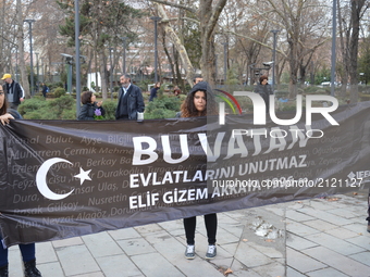 People hold a banner during a commemoration to the 1st anniversary of the Guven Park bombing in Ankara, Turkey on March 13, 2017. A car bomb...