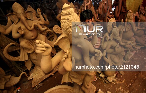 Local artists busy to built clay idols of elephant headed God Ganesha at a workshop ahead of the Ganesha Chatruthi festival in the eastern I...