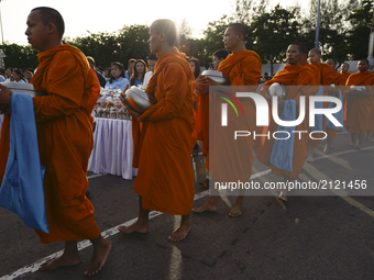 Thai Buddhist monks receive alms during as part of celebrate the Queens Sirikit' 85th birthday in Bangkok, Thailand, 12 August 2017. (