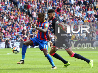 Crystal Palace's Wilfried Zaha holds of Huddersfield Town's Philip Billing
during Premier League  match between Crystal Palace and Huddersfi...