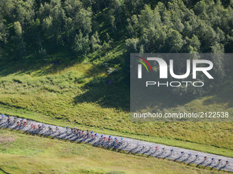 The peloton of riders during the third stage, the 185.5km from Lyngseidet (Lyngen Alps) to Finnvikdalen (Tromso), during the Arctic Race of...