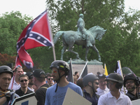 Free speech demonstrators hold shields and flags during the Unite the Right free speech rally at Emancipation Park in Charlottesville, Virgi...